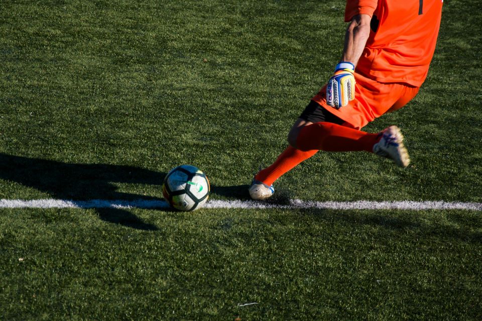 Man kicking soccer ball